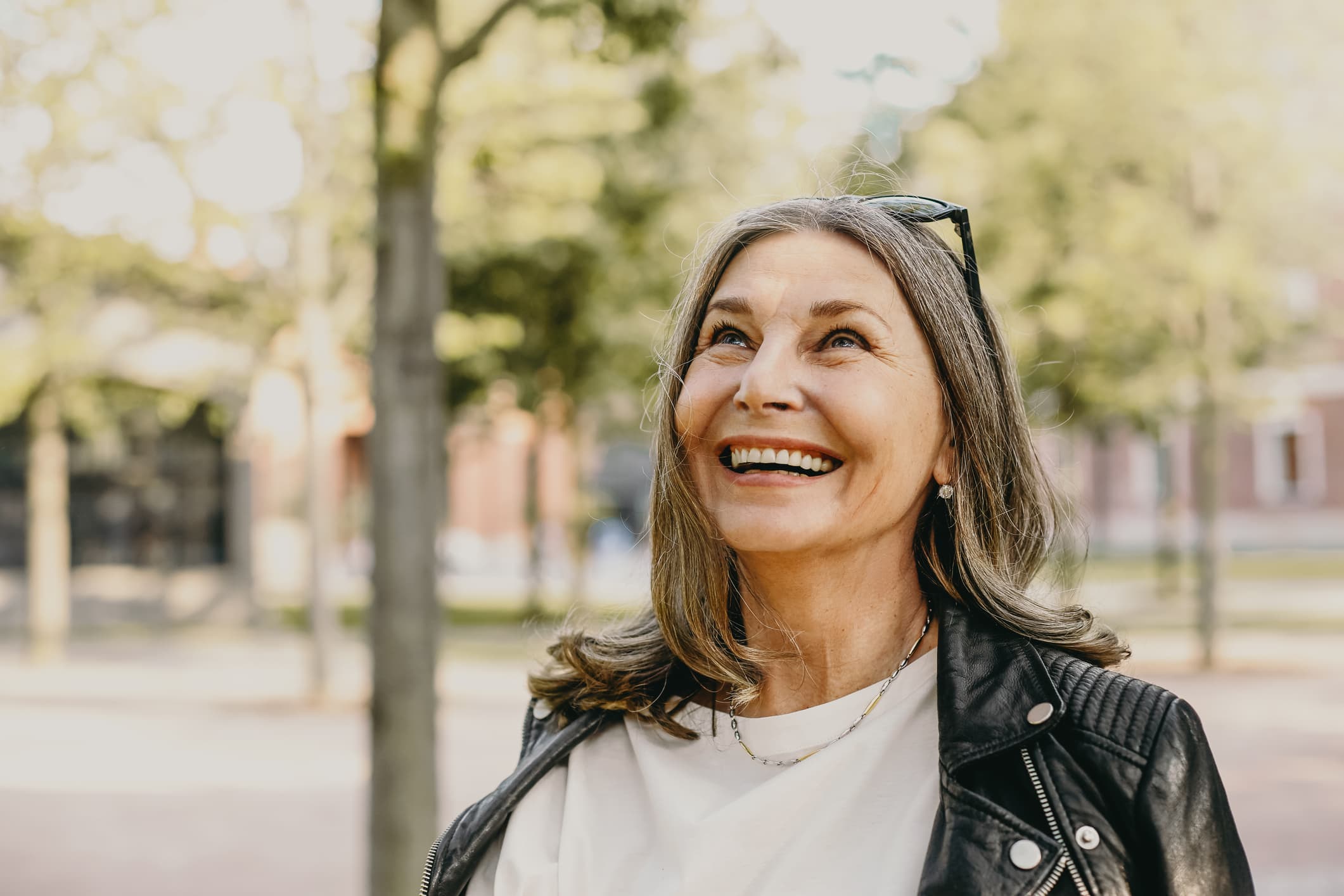 Older woman with kind eyes, contemplative